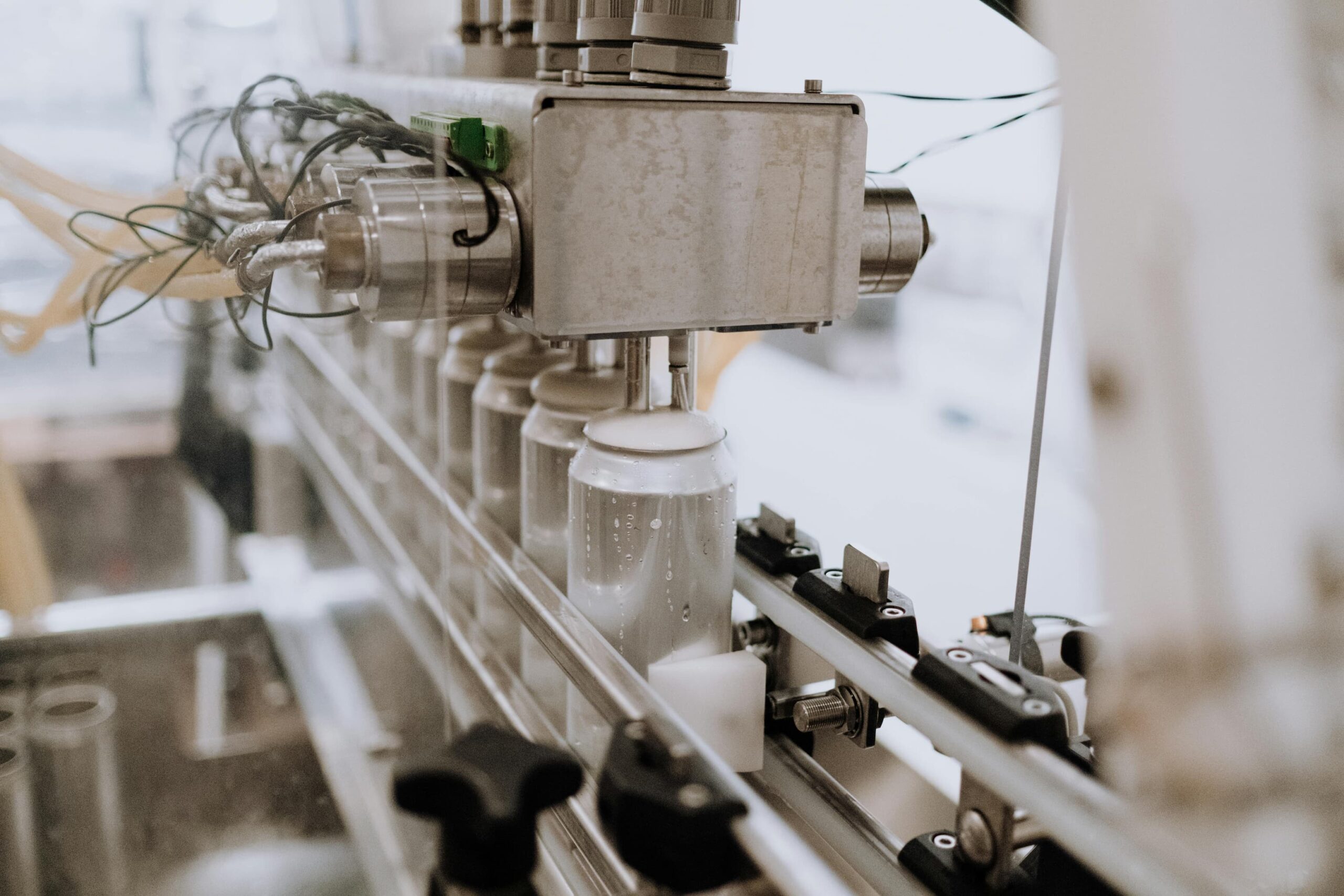 Cans being processed in a drinks factory 