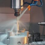 Coolant being sprayed during industrial drilling
